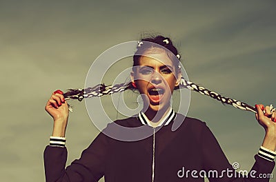 Spring concept. Amazed girl with dental braces on teeth in open mouth Stock Photo