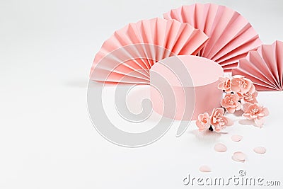 Spring cylinder podium mockup decorated of semicircle asian fans, twig pink sakura flowers, petals on white wood background Stock Photo