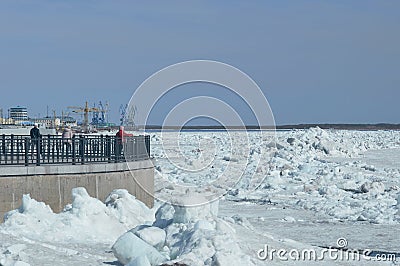 Spring drifting of ice on the Amur River. View of the embankment of the city of Blagoveshchensk, Russia. River port cranes. Large Editorial Stock Photo