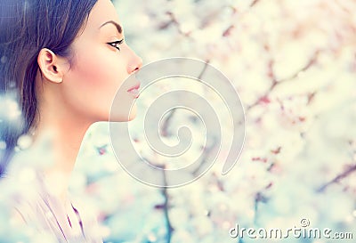 Spring fashion girl in blooming trees Stock Photo