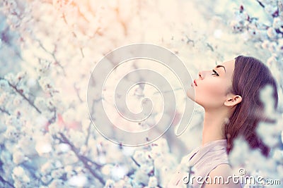 Spring fashion girl in blooming trees Stock Photo