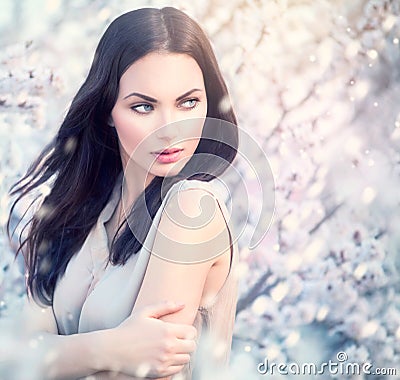 Spring fashion girl in blooming trees Stock Photo