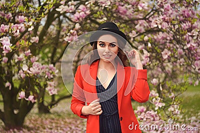 Spring fashion girl outdoors portrait in blooming trees. Beauty Romantic woman in flowers. Sensual Lady enjoying Nature. Stock Photo