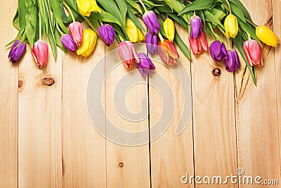 Spring Flowers bunch at wood floor texture. Beautiful Tulips bou Stock Photo