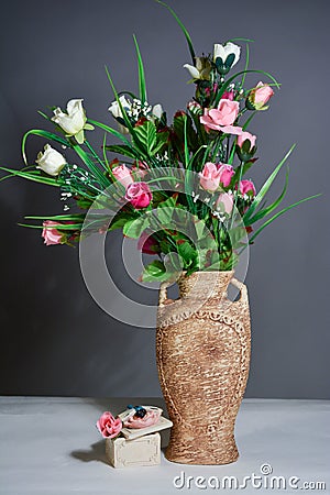 Spring flowers in a vase on grey background Stock Photo