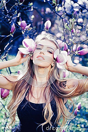 Spring girl in blooming garden. Summer girl and sensual moment. Beauty woman outdoors in blooming trees. Beauty woman in Stock Photo