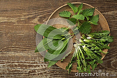 Spring healthy food with wild garlic dandelion and nettle leaves Stock Photo