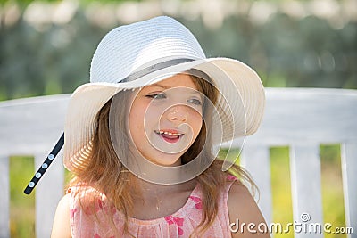 Spring kids girl outdoor, child cute face. Cute little girl swinging on the meadow in summer day. Stock Photo