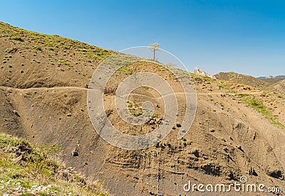 Spring landscape with tracking path in mountains near Sudak town on a Black Sea shore, Crimean peninsula Stock Photo