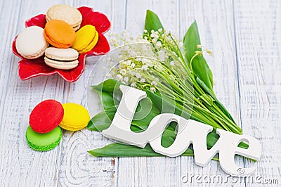 Spring, love, lily of the valley and macaroons Stock Photo