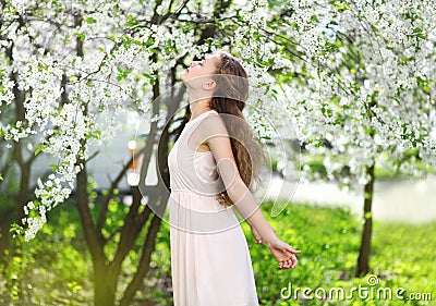 Spring mood, cute girl smell flowering tree Stock Photo