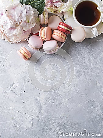 Spring mood still life with macaroons, flowers and cup of coffee Stock Photo