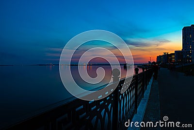 Spring night city Saratov quay under sunset. Street decorative lights and beautiful sky Stock Photo