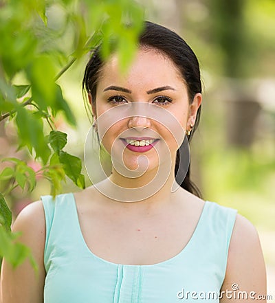 Spring positive smiling young female portrait in garden Stock Photo