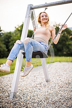 Spring romantic woman swinging on swing Stock Photo