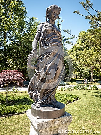 Spring season represented by statue. Garden of the crystal palace in Porto. Editorial Stock Photo