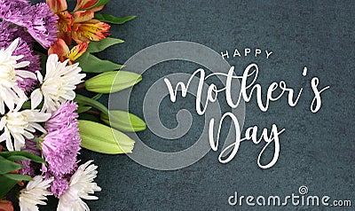 Happy Mother`s Day greeting holiday script over dark blackboard background texture Stock Photo