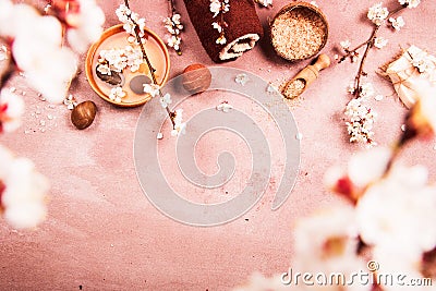 Spring Spa concept: sea salt, flowering cherry branches, towel, soap. Top view. Stock Photo