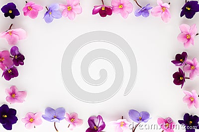 Spring or summer flower composition with edible violets on white background. Flat lay, copy space. Healthy life and flowers Stock Photo