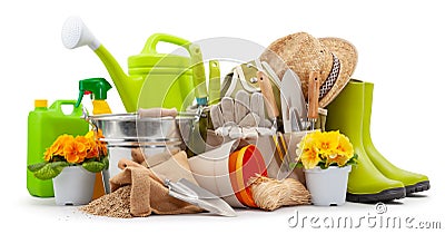 Spring time blooms, pots colorful primroses and vase of daisies, green rubber boots and watering can. Gardening tools, trowel, Stock Photo