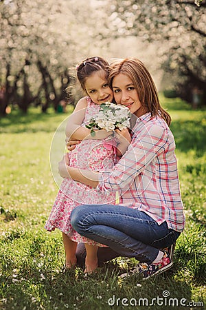 Spring vertical portrait of happy mother and kid daughter Stock Photo