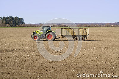 Spring work at farm. Farmer in tractor preparing the field for sowing. Farmer land and traktor Stock Photo