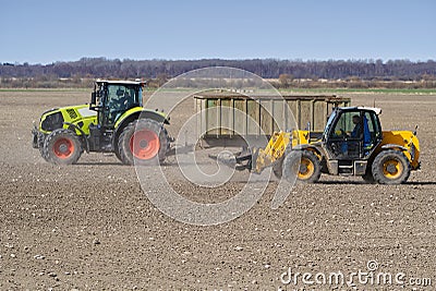 Spring work at farm. Farmer in tractor preparing the field for sowing. Farmer land and traktor Stock Photo
