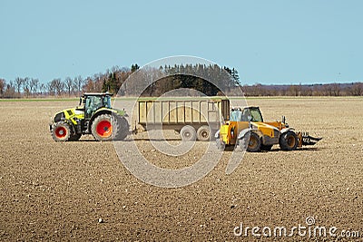 Spring work at farm. Farmer in tractor preparing the field for sowing. Farmer land and traktor Stock Photo