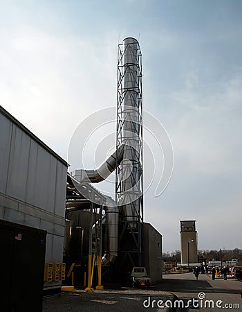 Stainless Steel Smokestack Against a Blue Sky Editorial Stock Photo