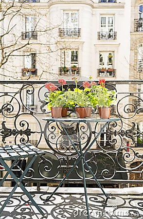 Springtime with red geraniums on a balcony in Paris, France Stock Photo