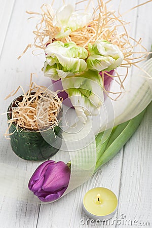 Springtime table decoration with tulips and lit candle Stock Photo