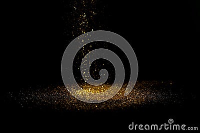 Sprinkle gold dust on a black background Stock Photo