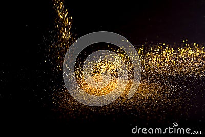 Sprinkle gold dust on a black background Stock Photo