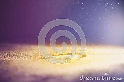 Sprinkle gold dust on a black background Stock Photo