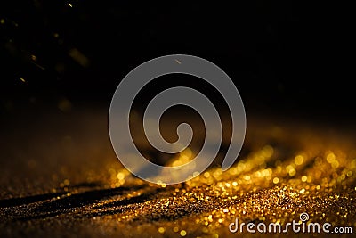 Sprinkle gold dust on a black background Stock Photo