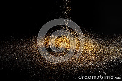 Sprinkle gold dust on a black Stock Photo