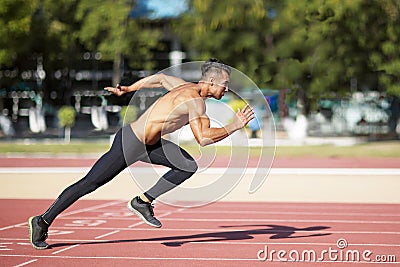 Sprinter leaving on the running track. Stock Photo