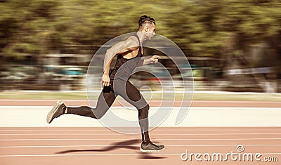 Sprinter leaving starting blocks on the running track. Explosive Stock Photo