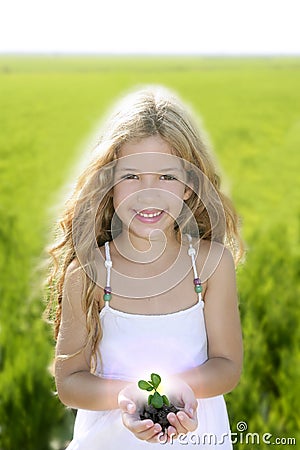 Sprout plant growing from little girl hands Stock Photo