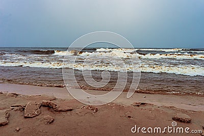 Spume of the harsh waves coming to the shore Stock Photo