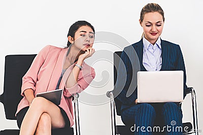 Spying businesswoman copying idea from another. Stock Photo