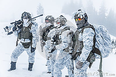 Squad of soldiers in winter forest Stock Photo