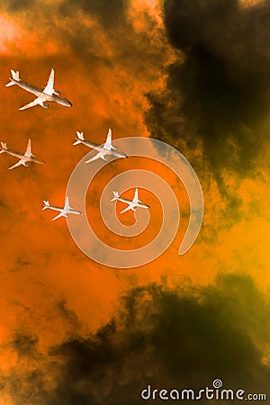Five airplanes in the sky flying over orange tempest sky Stock Photo