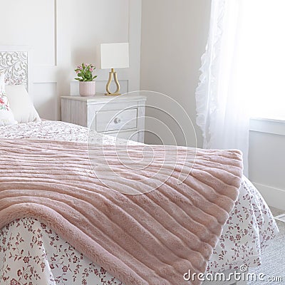 Square Bedroom interior with floral feminine beddings and decorative headboard on bed Stock Photo