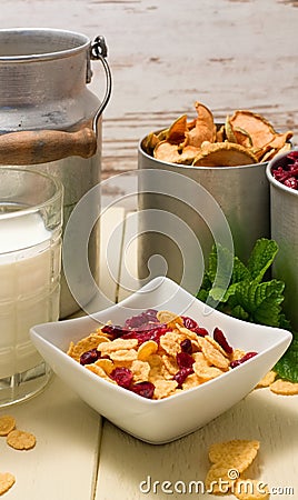 Square bowl with cornflakes and old can plus cups in background Stock Photo