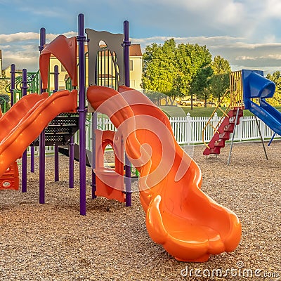 Square Bright orange and blue slides at a colorful fun playground for children Stock Photo