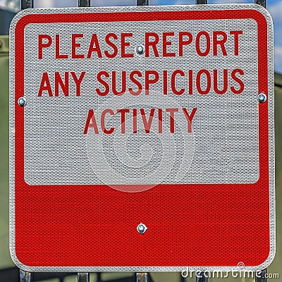 Square Close up of a sign that reads Please Report Any Suspicious Activity Stock Photo