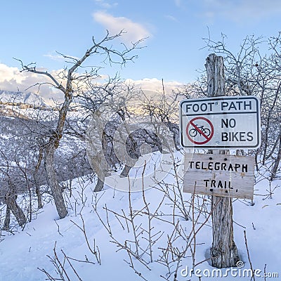 Square crop Signages at the Telegraph Trail of Wasatch Mountains buried in snow in winter Stock Photo