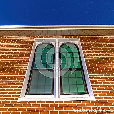 Square crop Sliding arched glas windows of a church in provo Utah against brick wall Stock Photo