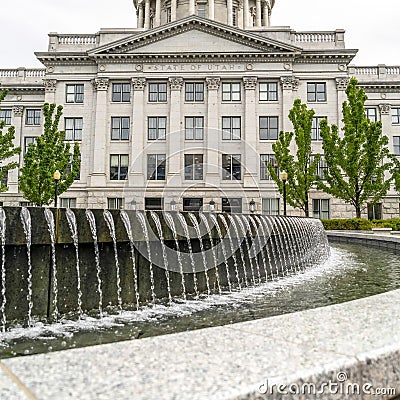 Square crop Water pool fountain against Utah State Capital building dome and pediment Editorial Stock Photo